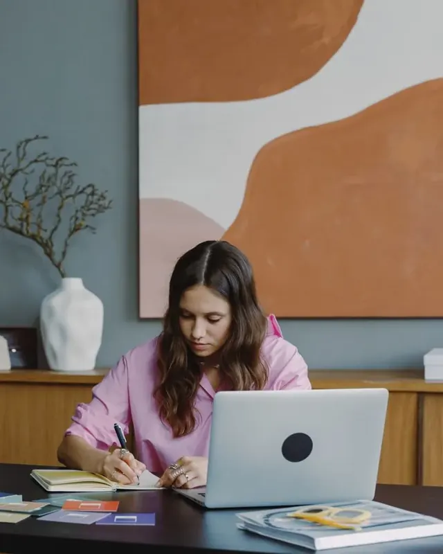 A graphic designer working on visuals at her desk
