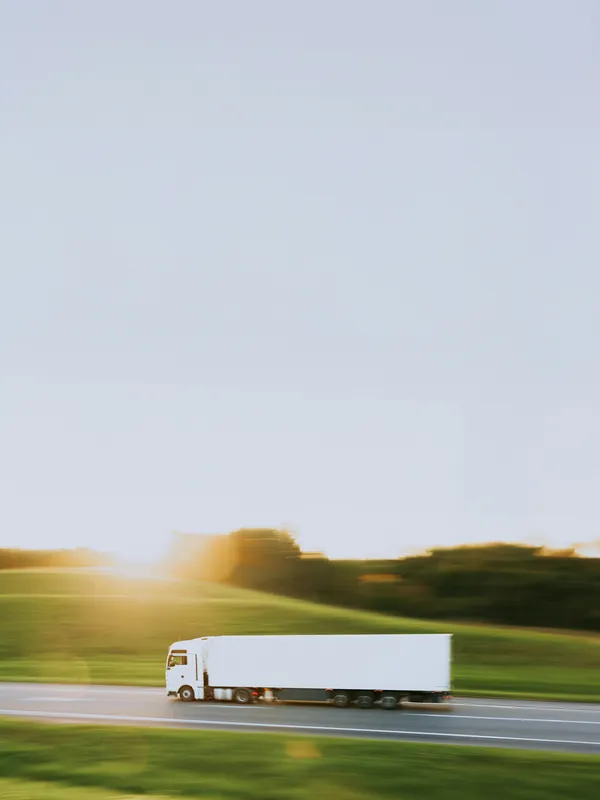 Freight truck moving through a landscape at speed